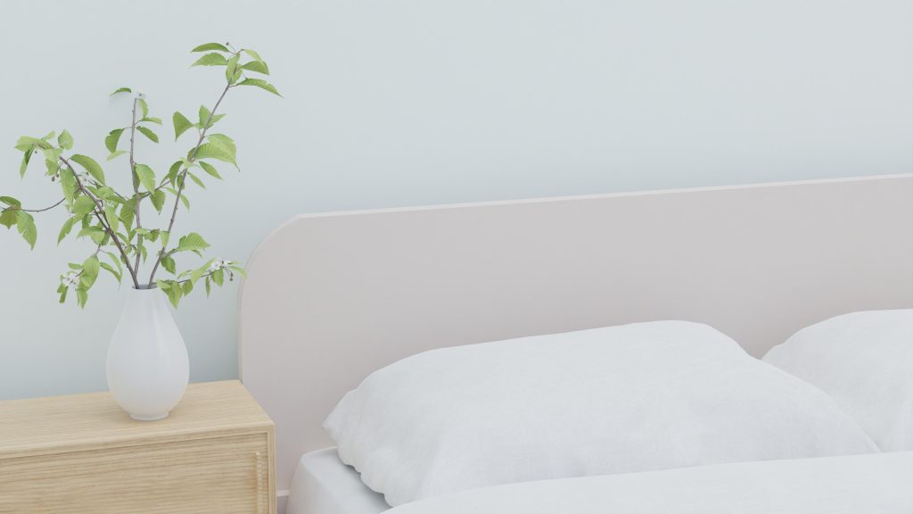 Chambre zen avec literie blanche et plantes vertes